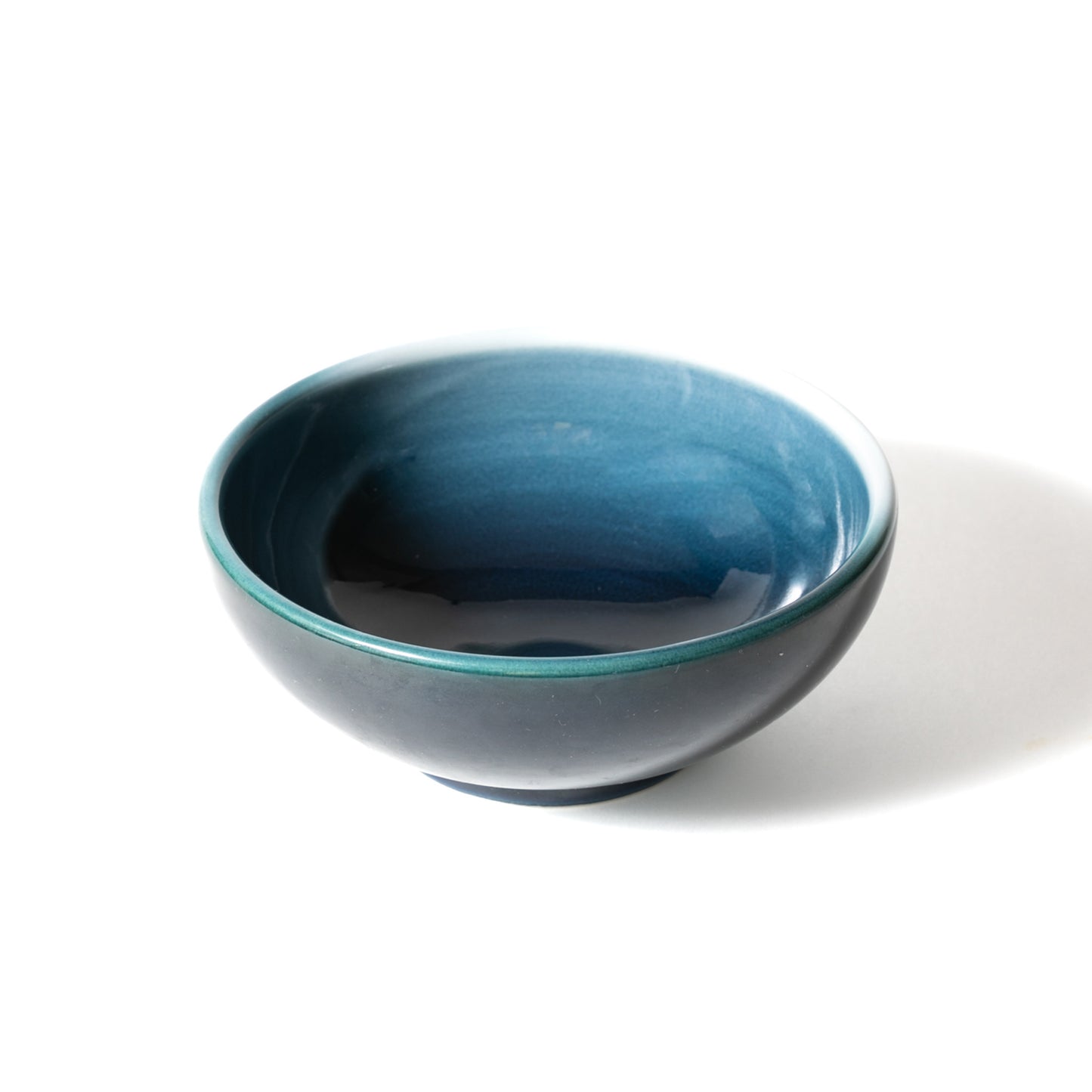 The top-angle view of empty Seto Blue Japanese donburi bowl shows rich azure interior glaze on a white backdrop.