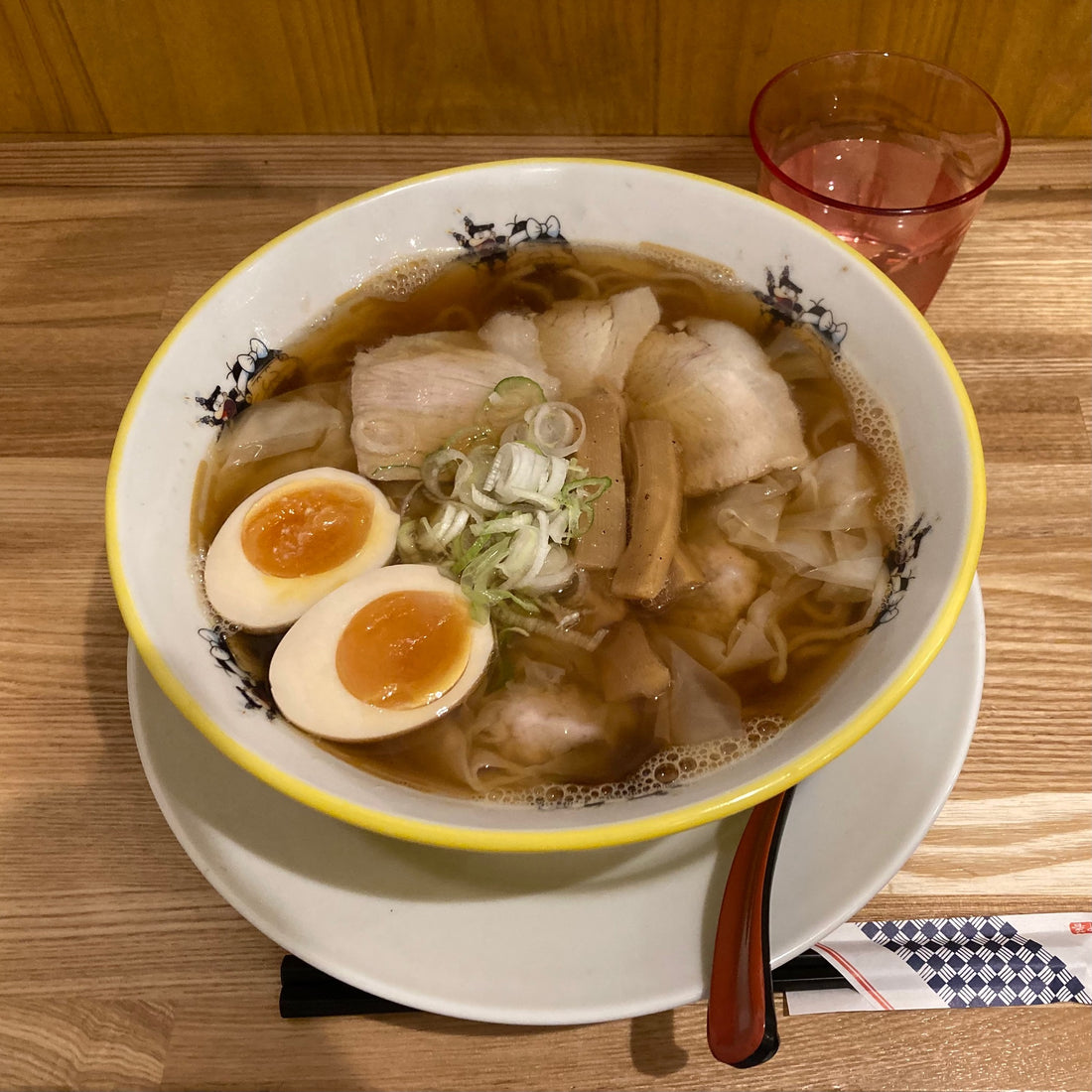 This is a shoyu, soy sauce based, ramen with boiled egg and sliced pork. It's about US$9.