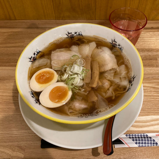 This is a shoyu, soy sauce based, ramen with boiled egg and sliced pork. It's about US$9.