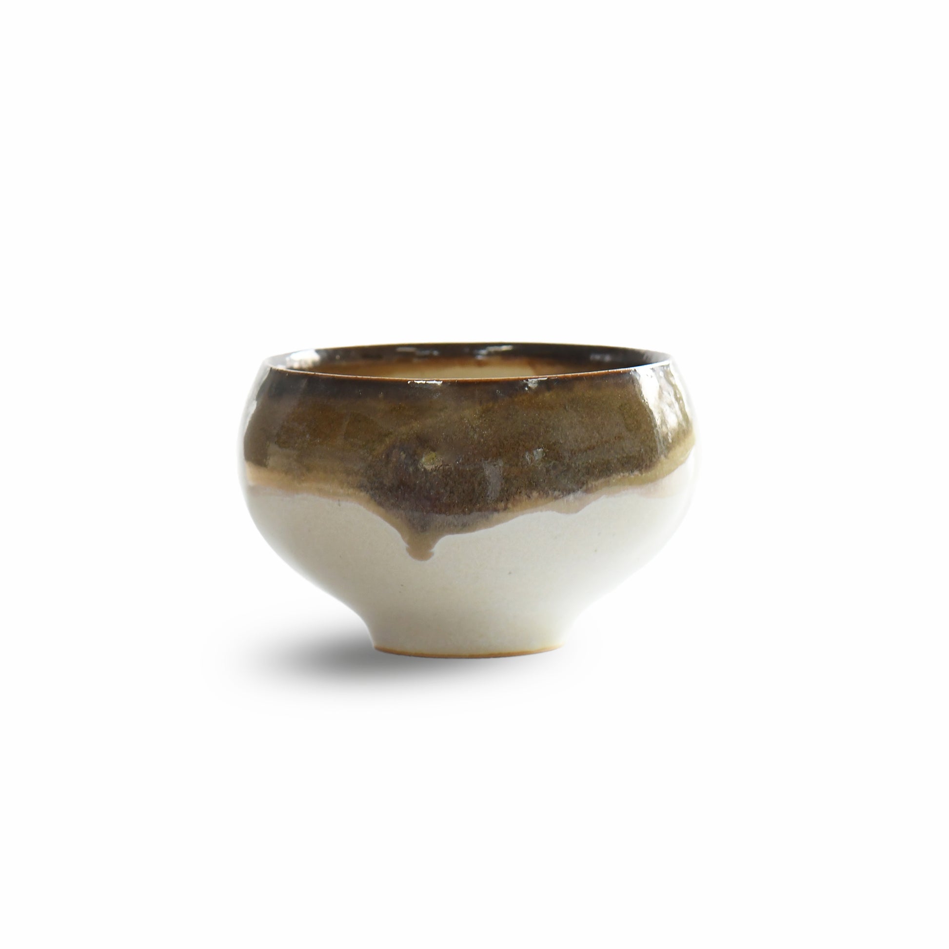 Angled side view highlighting rounded silhouette and layered glaze movement