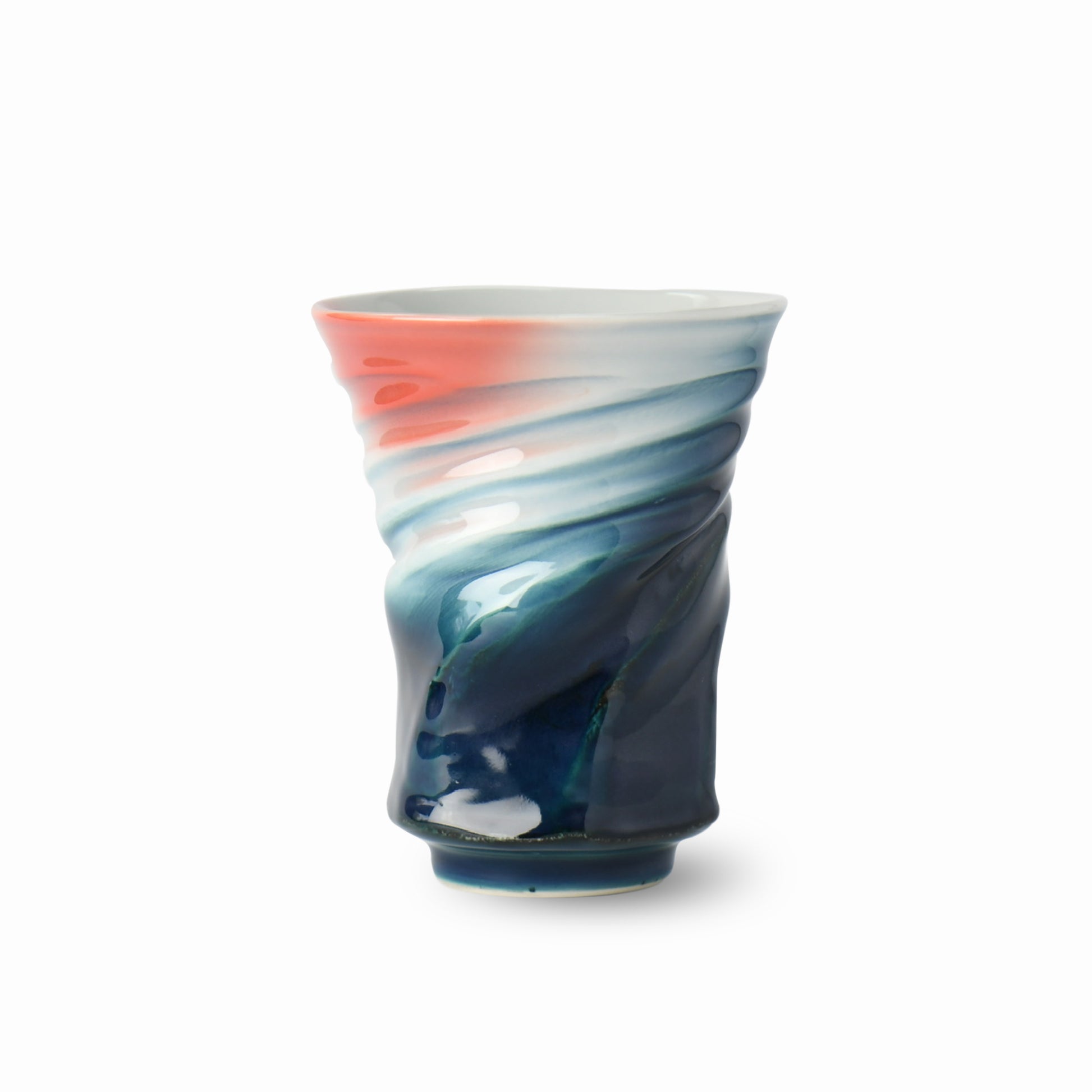 Front view of Yūkei, a sculptural Japanese ceramic vase in coral and indigo by Asato Ikeda and Yoshito Takenishi, showcasing twisted form and flowing glaze.