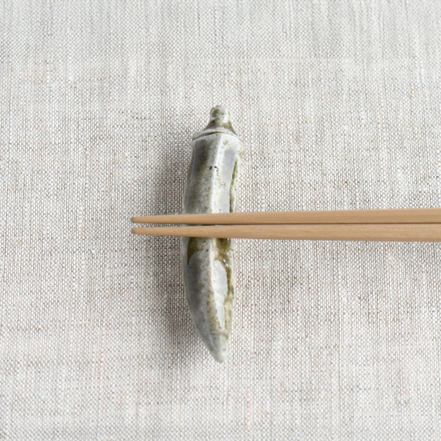 Bizen okra chopstick rest by Masato Miura shown with wooden chopsticks