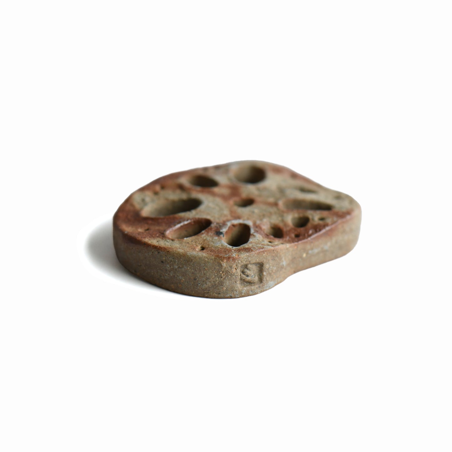 Close-up of the maker's mark on the handmade Bizen lotus root chopstick rest
