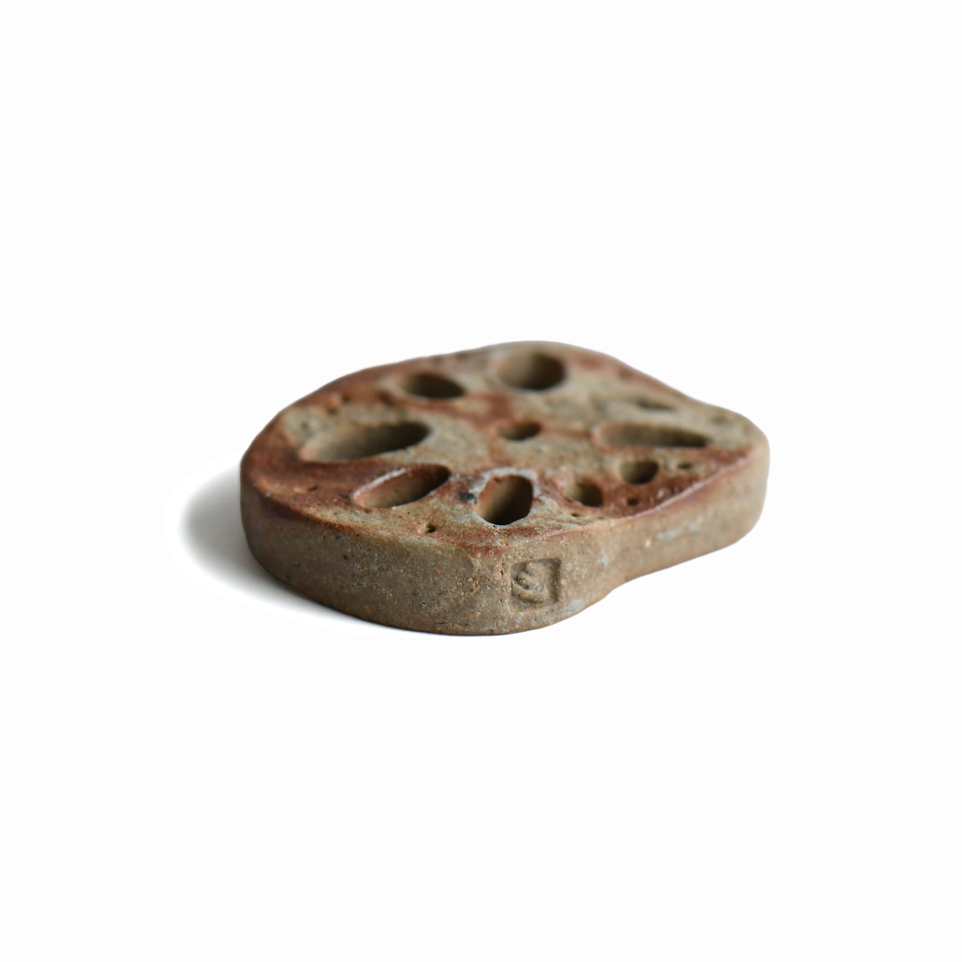 Close-up of the maker's mark on the handmade Bizen lotus root chopstick rest