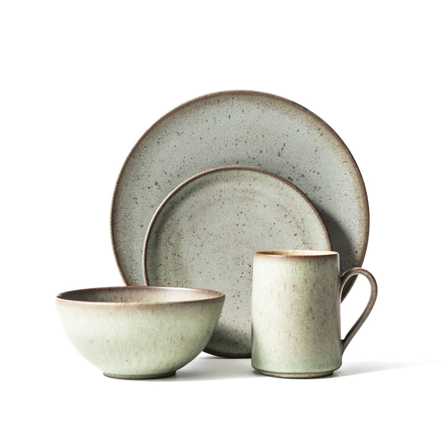 A 4-piece dinnerware set with matte opal green color, including two plates, a soup bowl, and a mug.