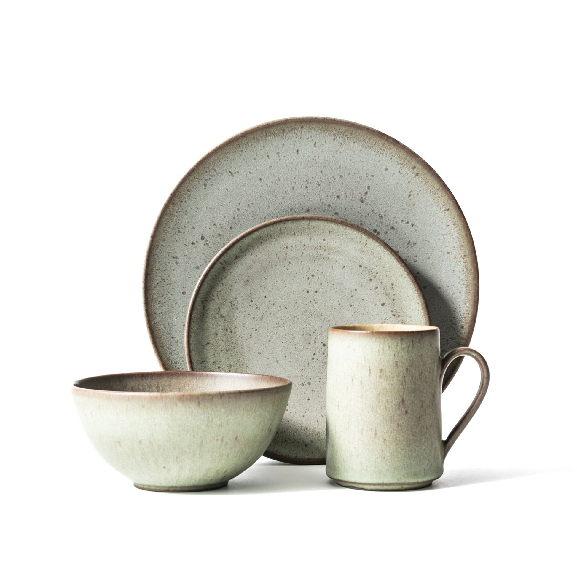A 4-piece dinnerware set with matte opal green color, including two plates, a soup bowl, and a mug.