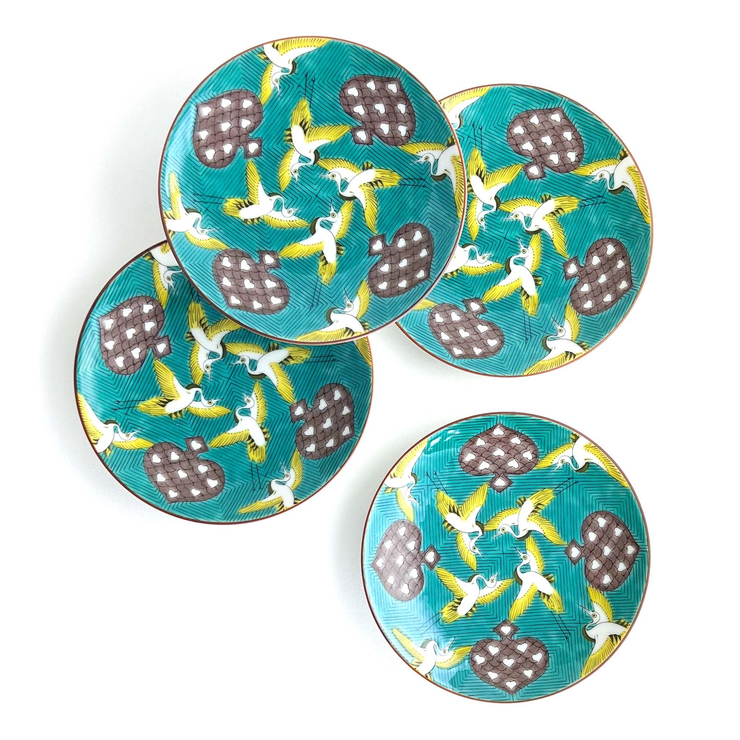 Set of 4 accent plates - yellow and white birds flying among spades rich green background 