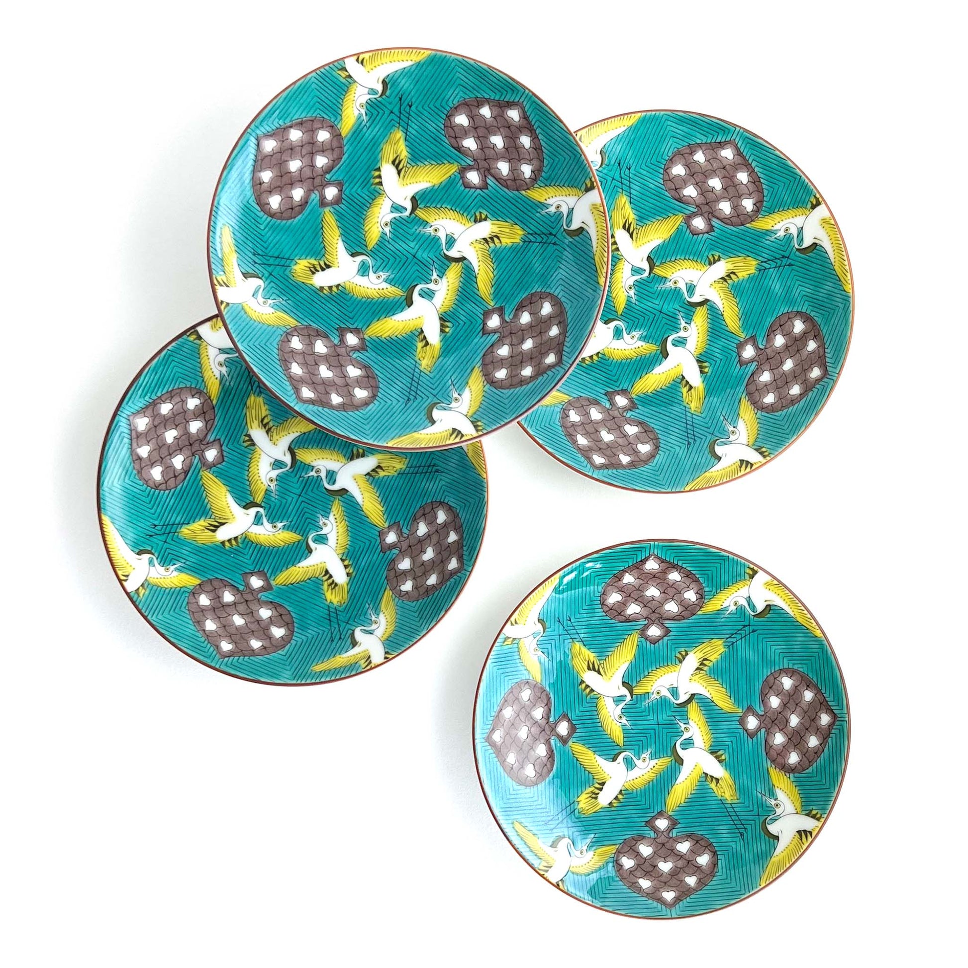 Set of 4 accent plates - yellow and white birds flying among spades rich green background 