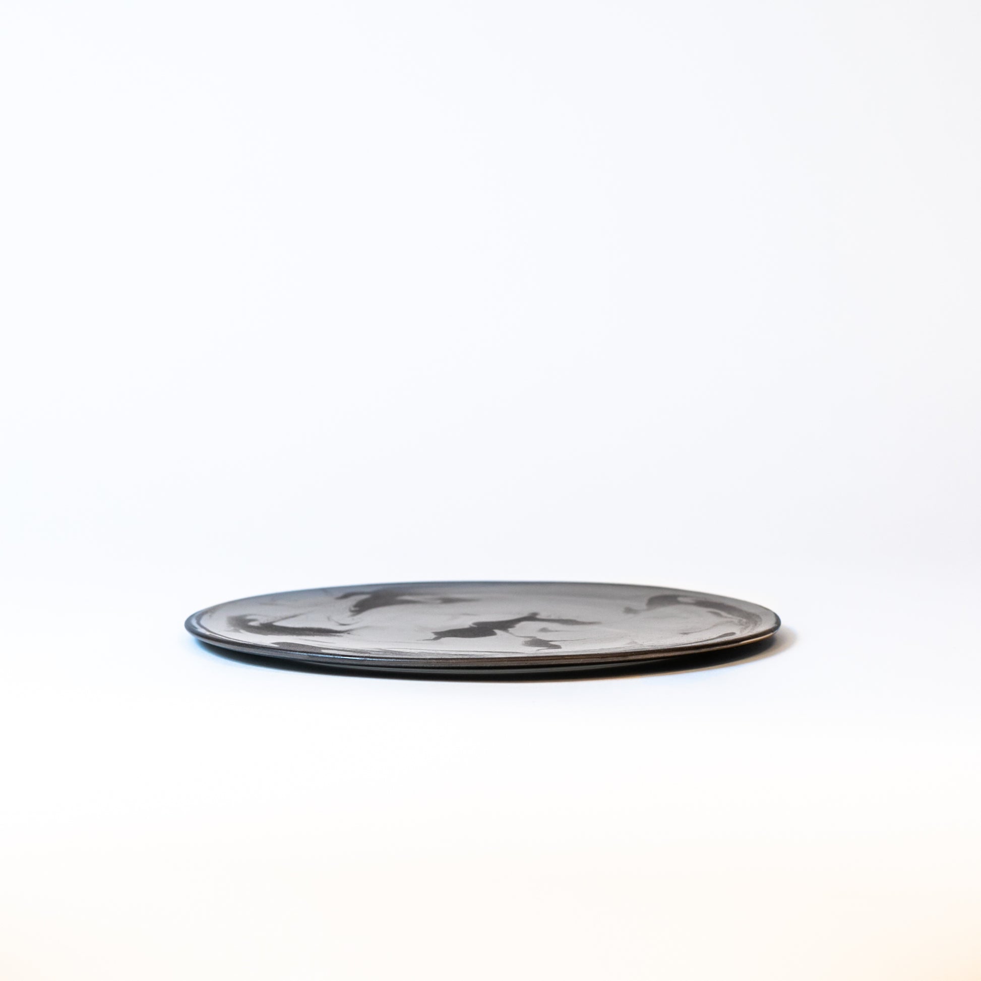 Side view of the plate. About 0.5 inches high. Beautiful flat plate.
